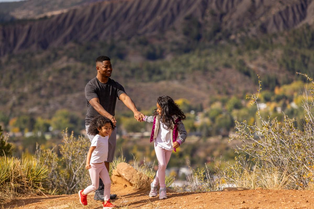 Family Hiking on the Rim Trail During Fall